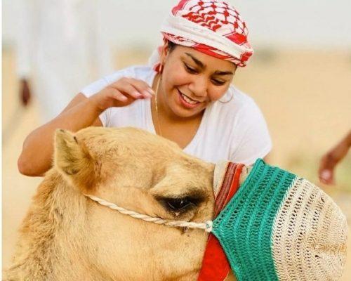 guest with camel in Dubai desert dune image